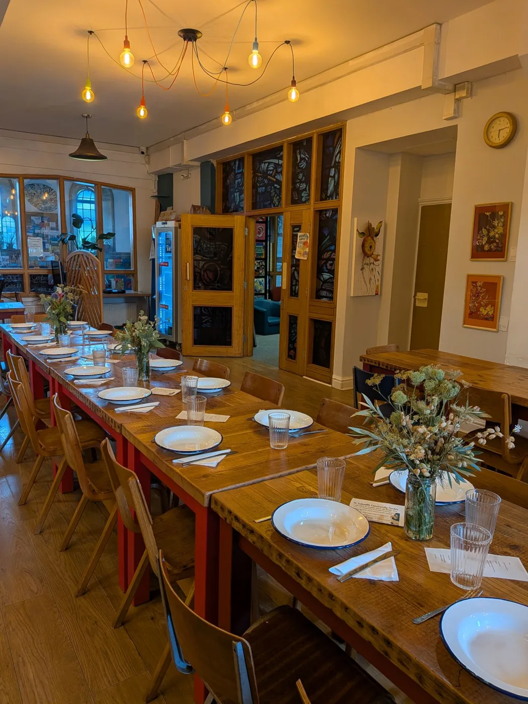Long tables laid for a meal inside St Sidwell's Community Centre